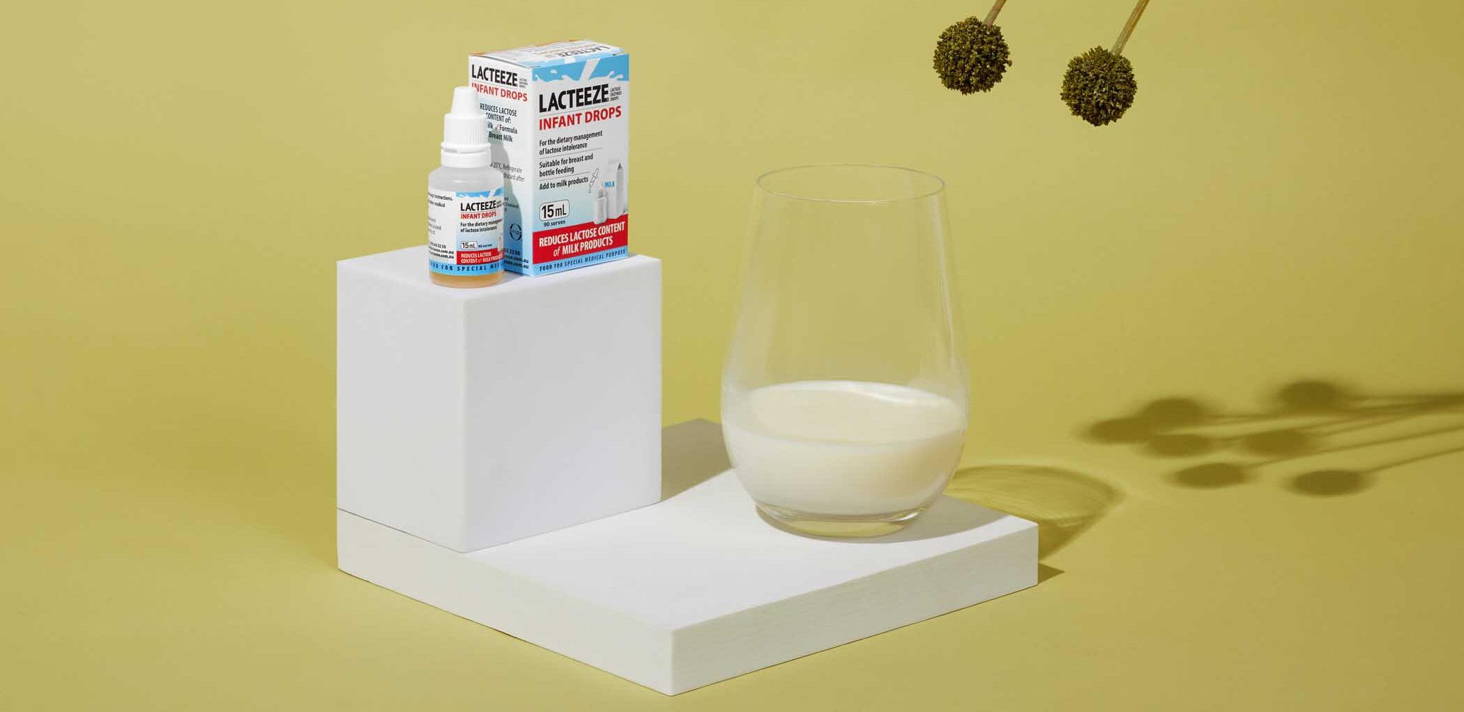 Lacteeze Infant Drops beside a Glass of milk