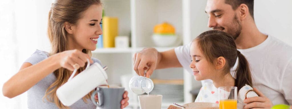 Mom and Dad pouring milk in a cup