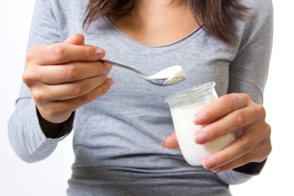 female-eating-yoghurt-with-lactose