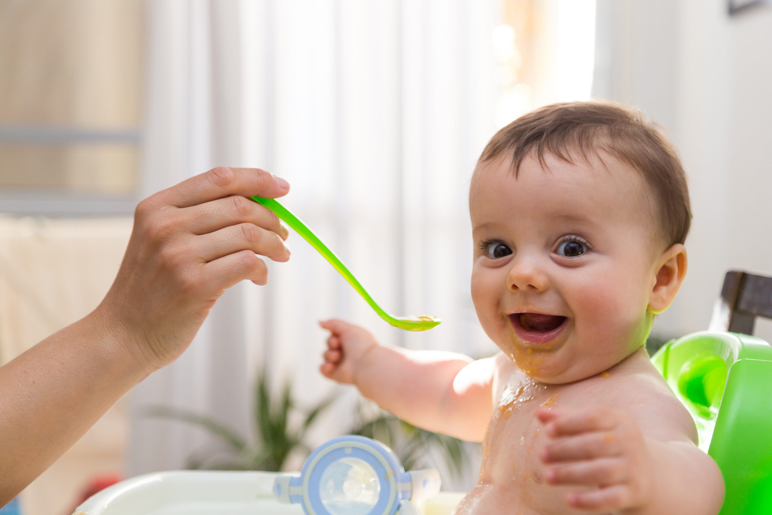 Happy baby eating food